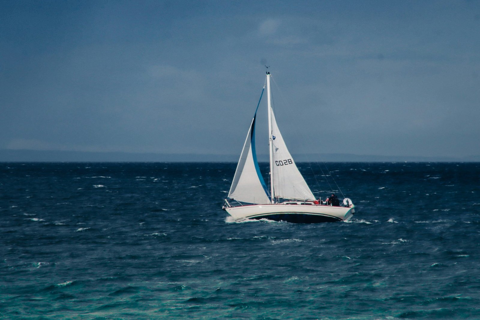 a sailboat in the middle of the ocean